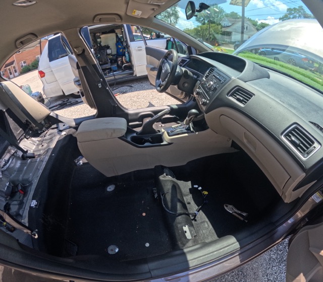 Debris underneath vehicle seats before interior restoration Maple Shade NJ